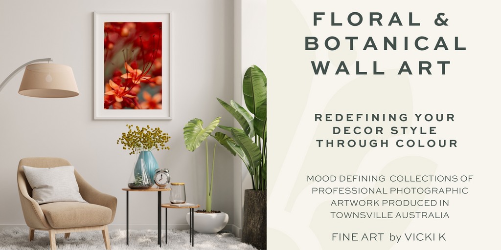 Red tropical flowers are wall art displayed in a lounge room with beige furniture, a couch, lamp, side table and green plants that compliment the fine botanical photographic wall art 