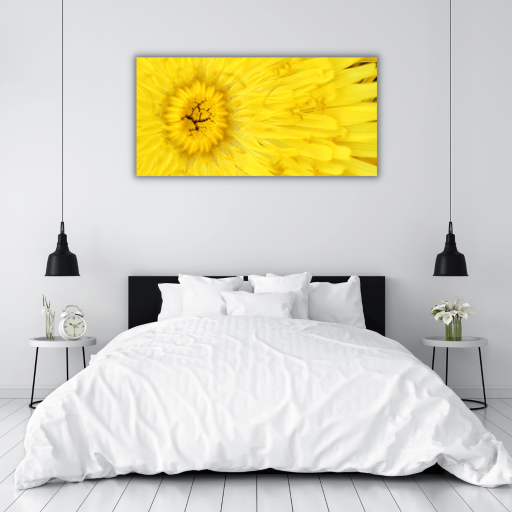 bright yellow landscape formation fine art flower and botanical wall art photography sits on the wall above the bed in a room full of white and dashes of black fittings and decor. The yellow artwork brings harmony and energy to the minimalist mood. 